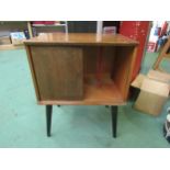 A wooden record cabinet with sliding front, raised on round tapering legs