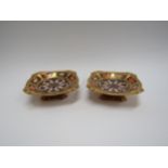 A pair of Royal Crown Derby Imari pattern canted square form pedestal bon-bon dishes, 14cm x 14cm