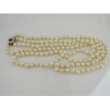 A double strand pearl necklace with 9ct gold clasp with green turquoise to centre, 60cm long
