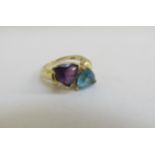 A dress ring set with a topaz and amethyst separated by three small diamonds, stamped 14kp (plated).