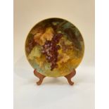A late 19th/20th Century Continental painted porcelain wall plaque, signed, 34cm diameter