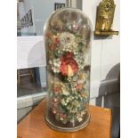 A tall glass dome housing a display of man-made and natural dried flowers, 81cm tall