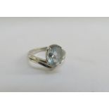 An unmarked ring set with an oval pale blue stone. Size N/O, 3g
