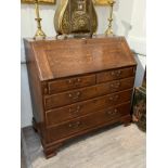 A 19th Century oak bureau, the ten drawer fitted interior with central stationery cupboard and