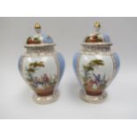 A pair of 19th Century Dresden lidded urns with handpainted cartouches, floral spray detail, 27cm