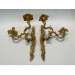 A pair of 19th Century gilt metal twin branch wall sconces with foliate scrolled design, one
