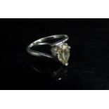A white gold diamond ring, the pear shaped yellow diamond 1.18ct, stamped 750. Size M/N, 2.5g