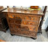 An early 18th Century walnut chest of two over three long drawers with cross-banding and satinwood