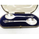 A Lee and Wigfull (Henry Wigfull) silver cased pair of Art Nouveau serving spoons, pierced handles