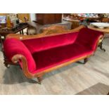 A William IV flame mahogany scroll arm sofa the carved raised back over turned and melon fluted fore