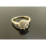 An unmarked gold diamond daisy ring. Size M, 3.7g