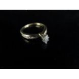 A gold ring set with a marquise cut diamond with diamond set shoulders, stamped 14k. Size N/O, 2.9g