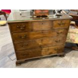A George III mahogany chest of three short over three graduated long drawers, swan neck handles,