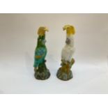 A pair of Mintons Majolica cockatoo figures, one in white with yellow crest, the other in green with