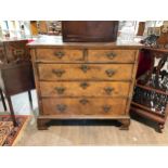 An 18th Century walnut chest of two over three drawers with feather edge banding, D-moulding ogee