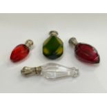 Four glass scent bottles including facet cut ruby, another in green and yellow, various makers and