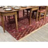A Turkoman woven silk rug, five rows of guls, multiple borders, tasselled ends, 362cm x 240cm