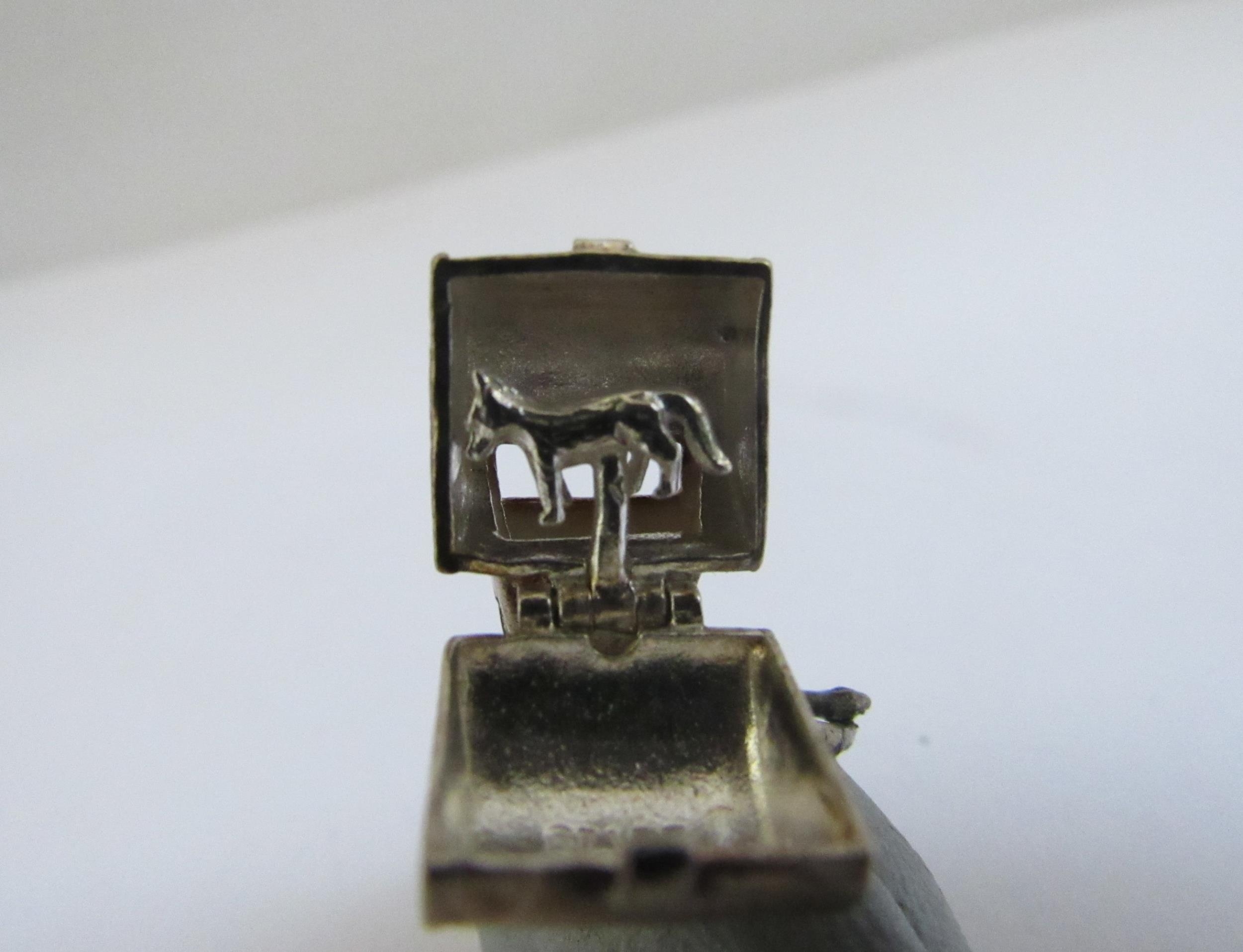 A white metal engine turned vesta with spring release lid and a "wolf whistle" charm - Image 3 of 3