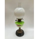 A Victorian oil lamp, white glass globular shade over green tint hand painted reservoir, brass