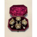 A William Evans silver condiment set, all over design of foliage and flowers, with a set of four