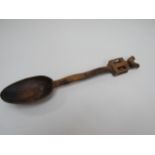 A 19th Century Welsh love spoon with a carved chicken finial atop a cage containing two balls on a