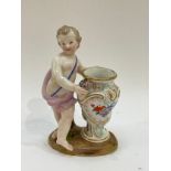A 19th Century Meissen figure of Putti next to an urn, handpainted, 13.5cm tall