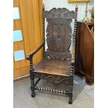 An 18th Century and later oak Wainscot armchair with spike finials, lozenge and scroll rosette