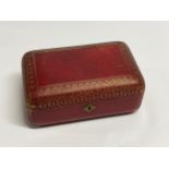 A 19th Century red leather casket with gilt tooled decoration to the exterior. With key. 27cm x 17cm