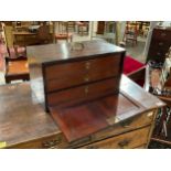 A George III mahogany three drawer cabinet with exposed dove tails the unusual brass semi circular