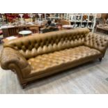 A Victorian Chesterfield settee of large proportions, approximately 9’ in length, upholstered in a