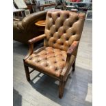 A leather Gainsborough style button back armchair