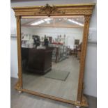 A Victorian gilt wood and gesso overmantle wall mirror with scrolled and foliate design, porcelain