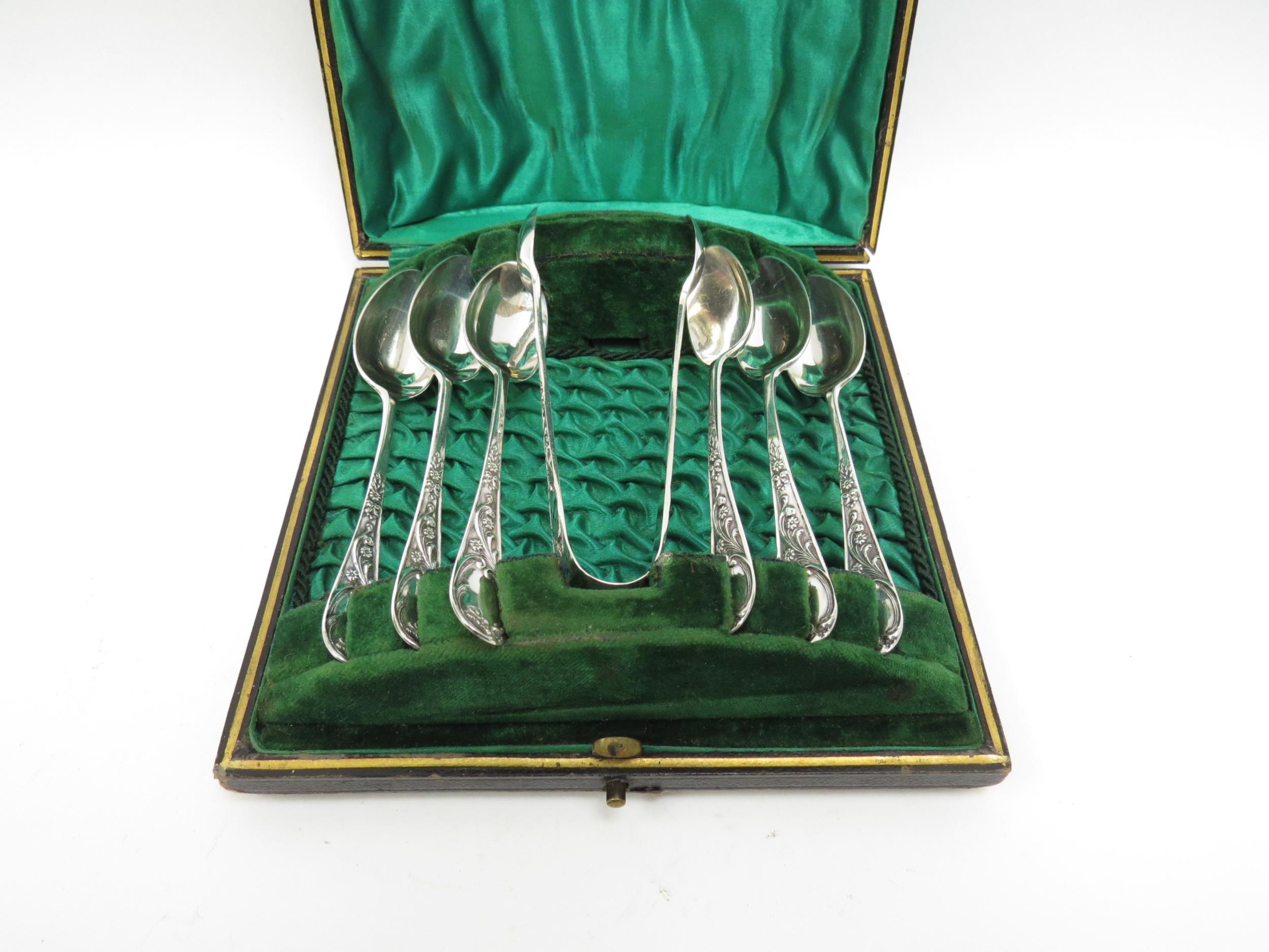 A set of six William Briggs & Co., silver coffee spoons and a pair of matching tongs in fitted case,