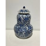 A Chinese blue and white lidded double gourd large jar with flowers and dragon design. (Some chips -
