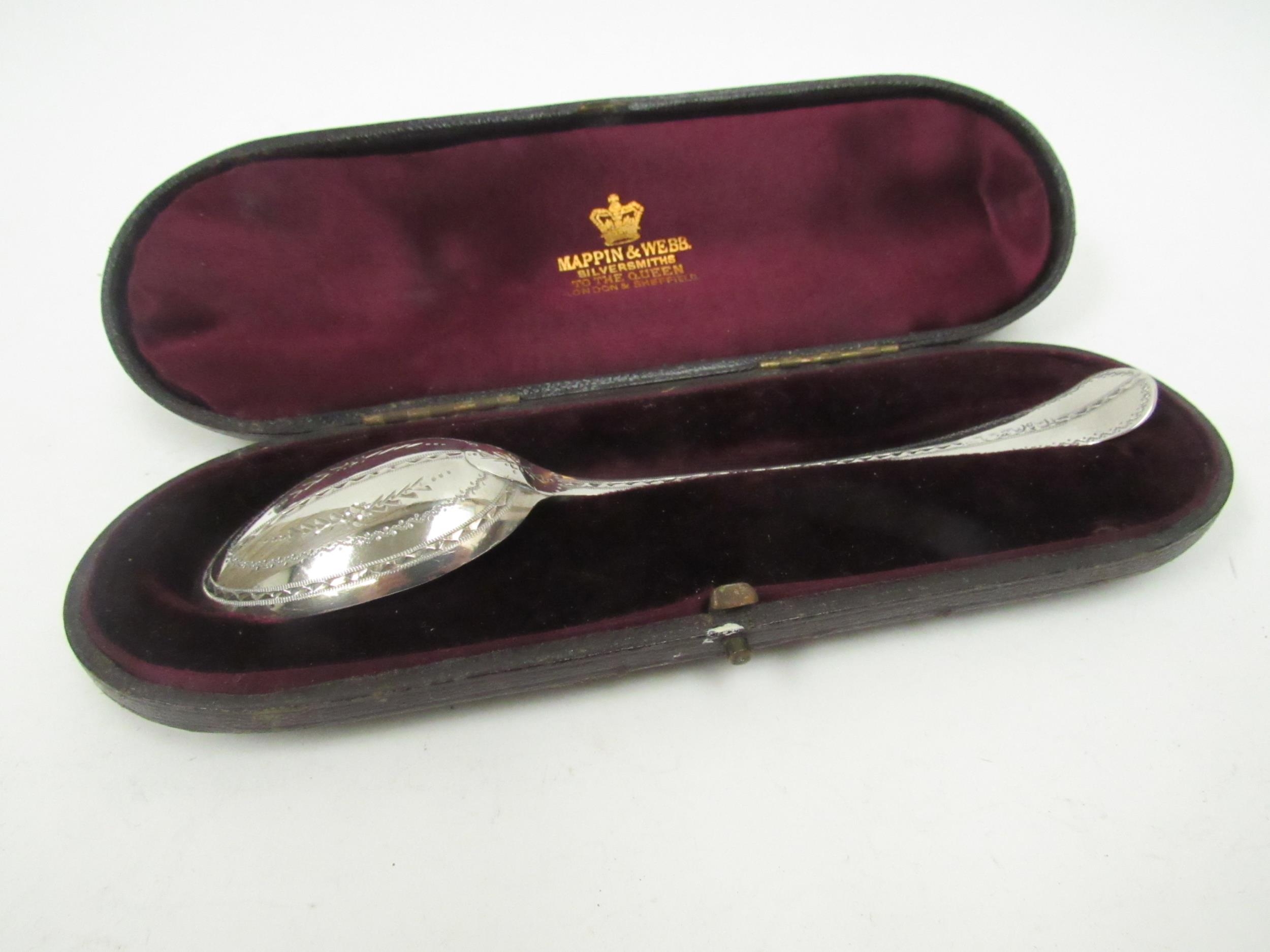 A silver spoon with bright cut detail marks indistinguishable in Mappin & Webb case, 24g