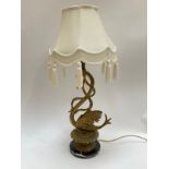 A decorative brass figured swan lamp with marble base, 60cm tall