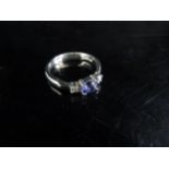 A 9ct white gold tanzanite and diamond ring. Size N, 3g