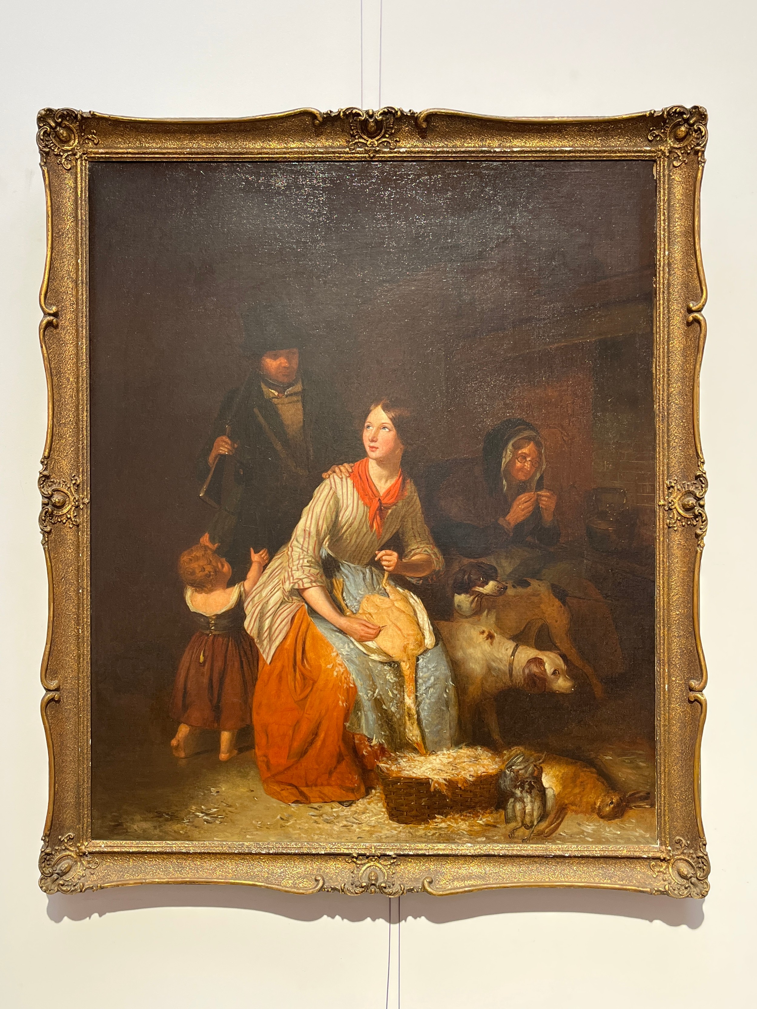 A 19th Century oil on canvas, interior family scene with young woman plucking a goose. Unsigned