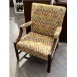 A Georgian open armchair with wide seat, colourful geometric upholstery