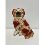 A large early Victorian Staffordshire finely modelled tan and white pottery King Charles spaniel,
