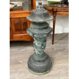 A bronze Chinese floor standing incense burner with dragon high relief detail on domed footed