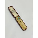 A Victorian gold and turquoise stickpin in box, unmarked