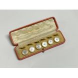 A set of 9ct gold and mother-of-pearl dress buttons, cased