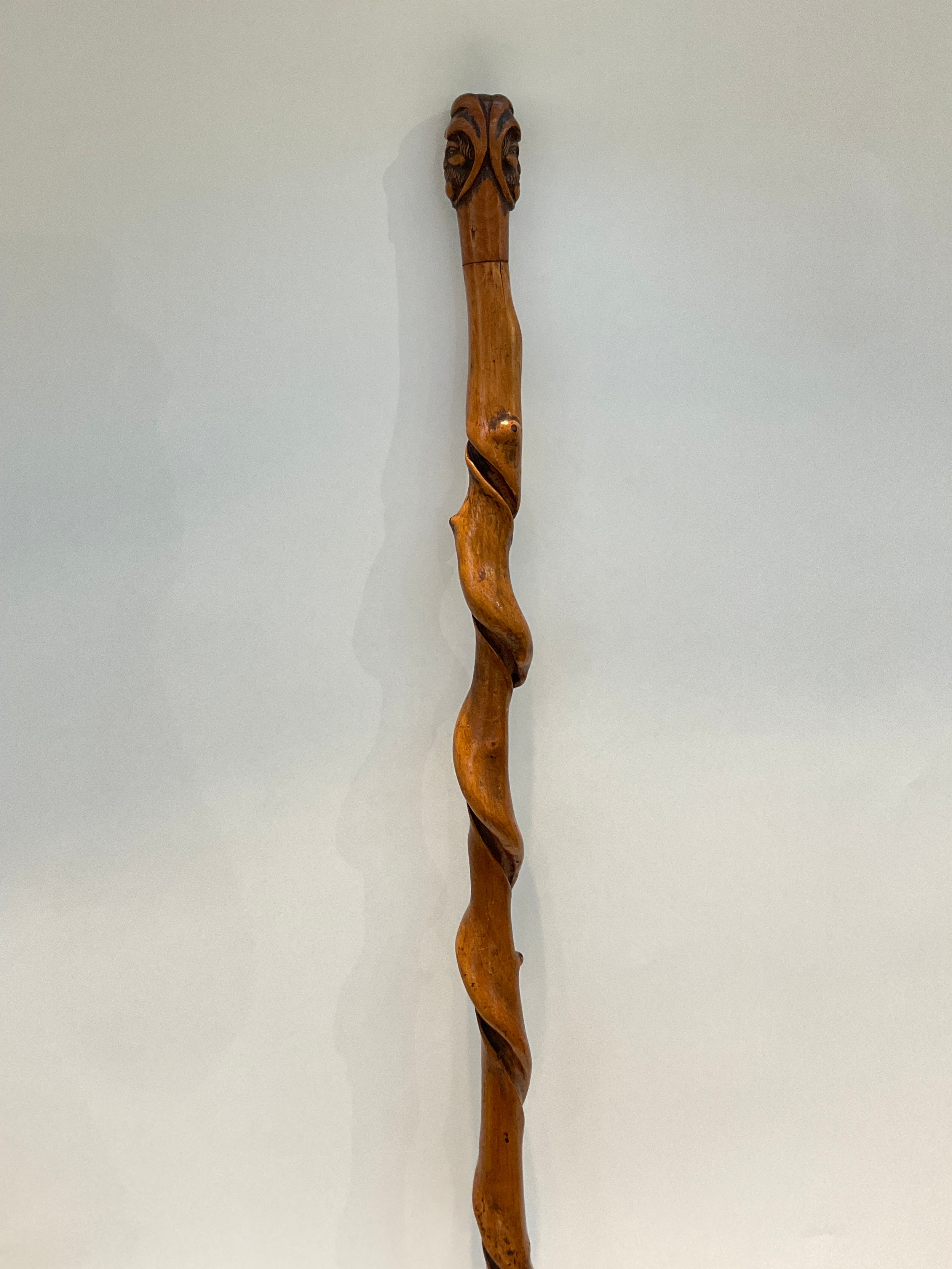 A knarled twisted wood walking cane with carved double ended mask of a man, 92cm long - Image 2 of 3