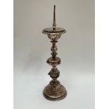 A silver plate pricket stand with winged putti/ lions head decoration the ornate stand having a trio