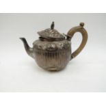 A Victorian silver teapot, floral relief, marks indistinct, fluted body, 428g