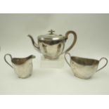 A Cooper Brothers & Sons Ltd., silver three piece teaset with treen handle and knop, Sheffield 1930,