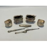 A quantity of silver items including napkin rings, a pair of table salts and a penknife etc.