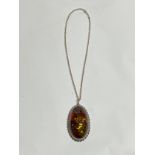 A modern large amber pendant on chain