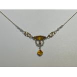 A gold necklace with leaf decoration and citrine coloured drop, clasp stamped 9ct, 42cm long, 3g